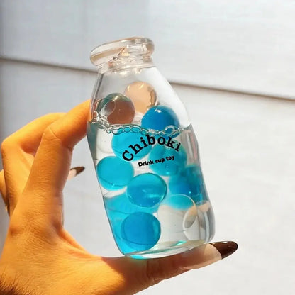 DumplingSquishys Bottle Pop Squishy – Mini Bead Bottle Stress Relief Toy – Soda Pinball Squishy Bottle