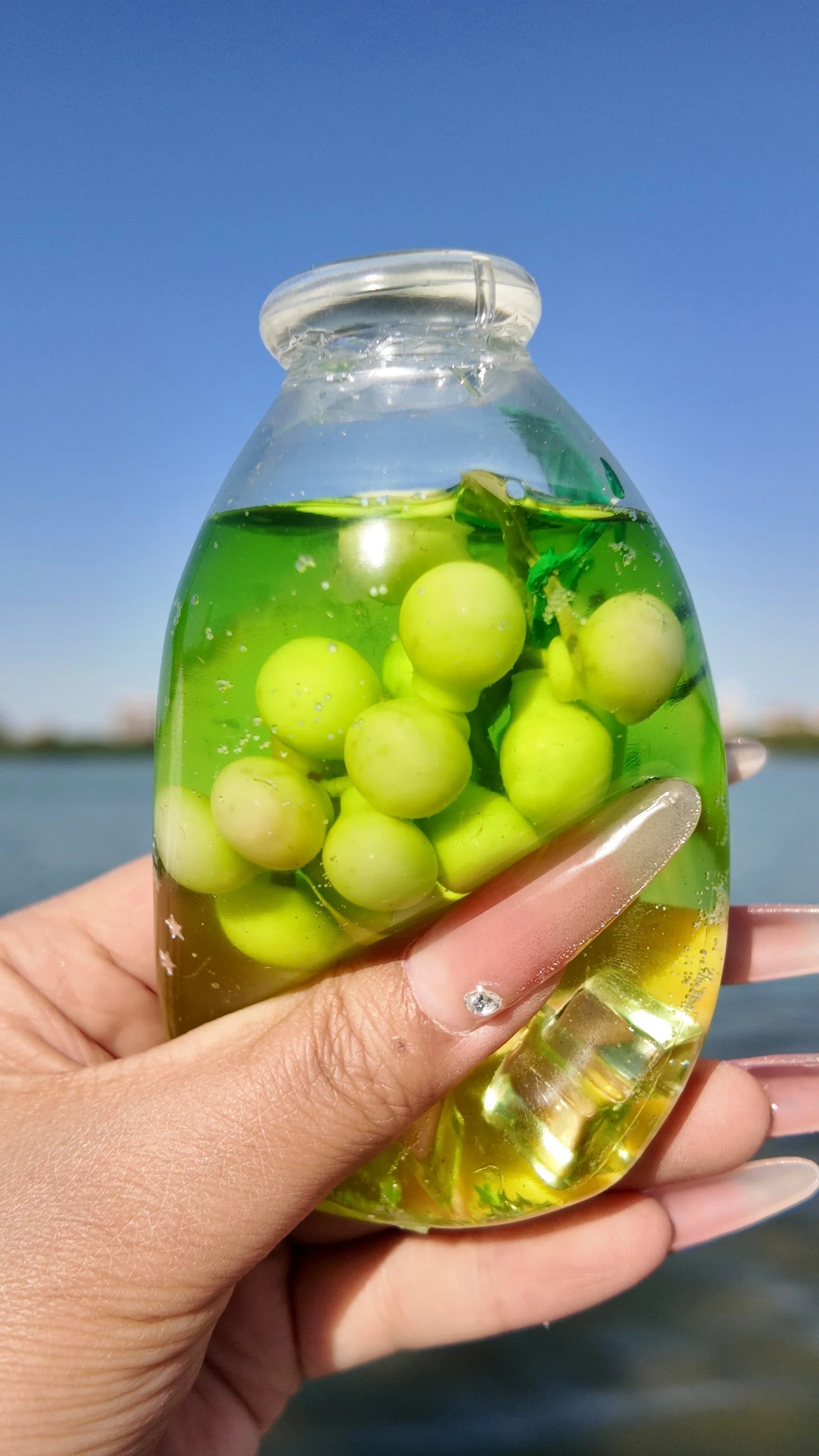 DumplingSquishys Bottle Pop Squishy – Jumbo Juice Bottle Stress Relief Toy – Sparkling Green Grape Bottle