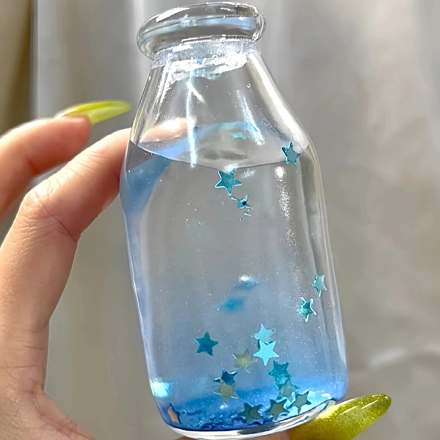 DumplingSquishys Bottle Pop Squishy – Clear Bead Bottle Stress Relief Toy – Gilded Galaxy Star Bottle