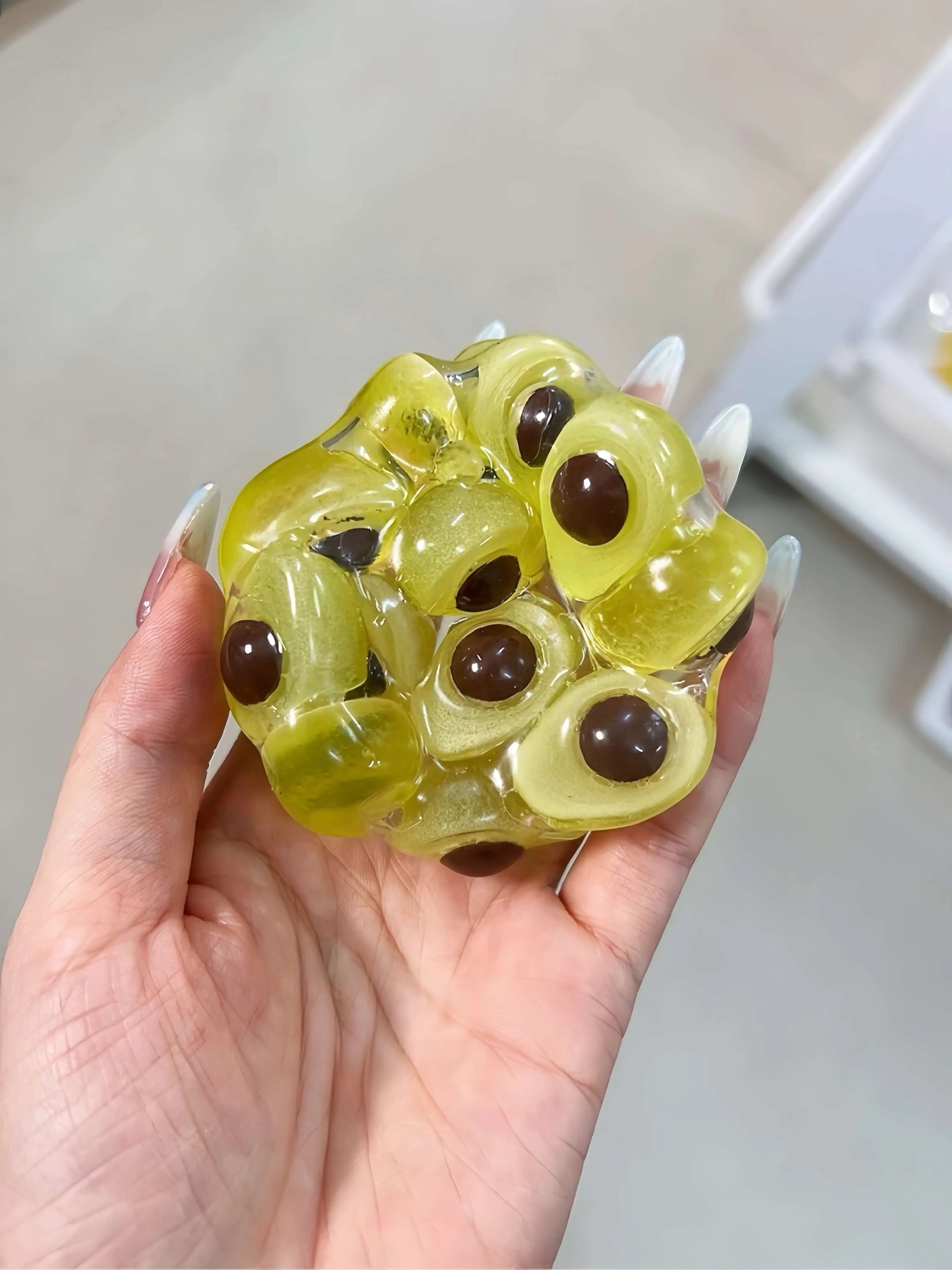 DumplingSquishys Gem Ball Squishy – Rainbow Bead Stress Relief Toy – Glow in the Dark Avocado